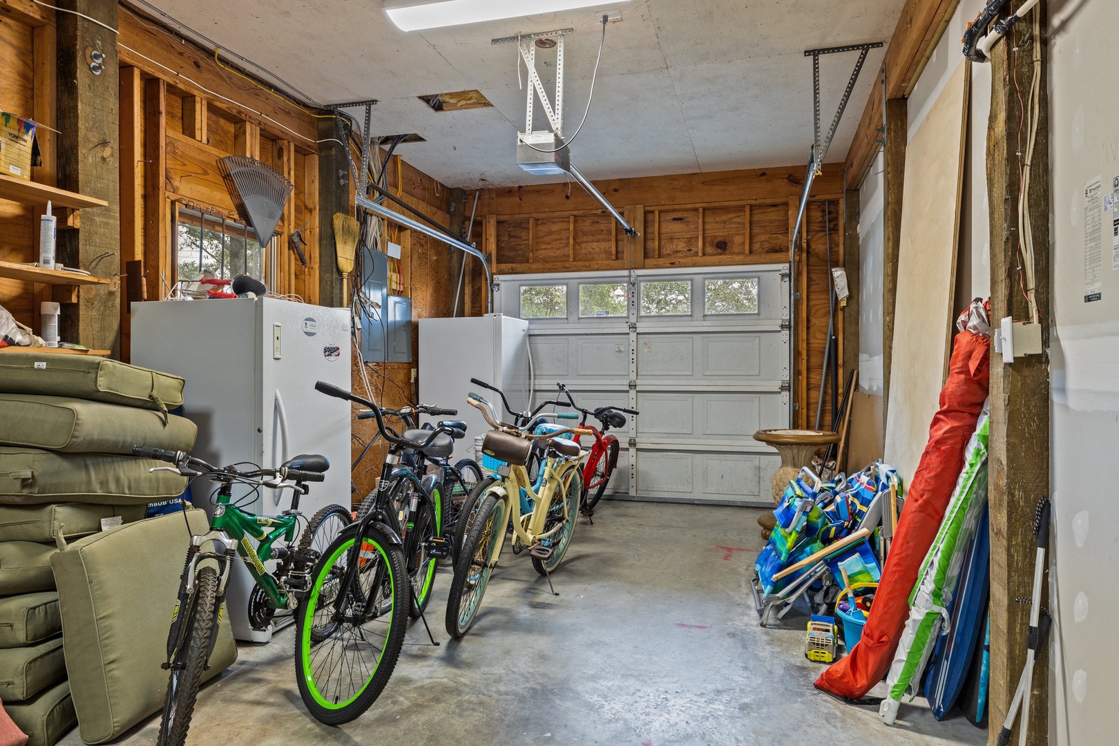 Your adventure awaits in this well-organized garage with bikes and outdoor gear ready for exploring the area.