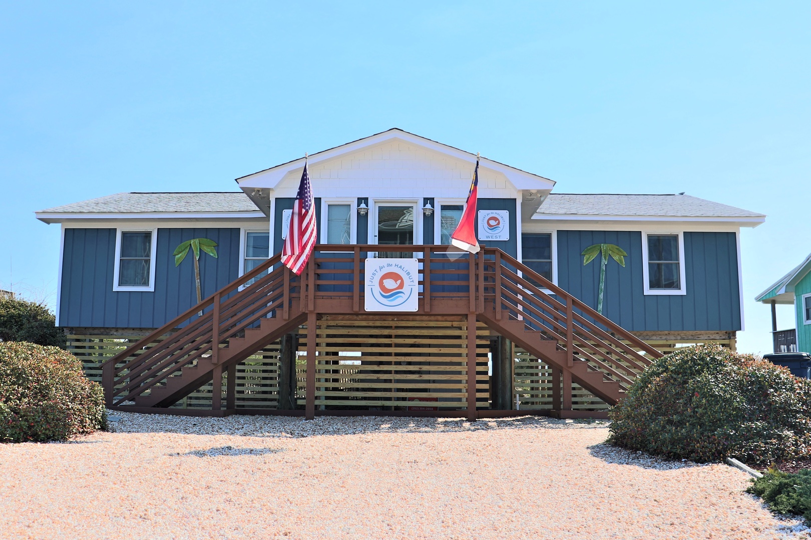 Charming beachside cottage with welcoming front deck and coastal charm awaits your arrival.