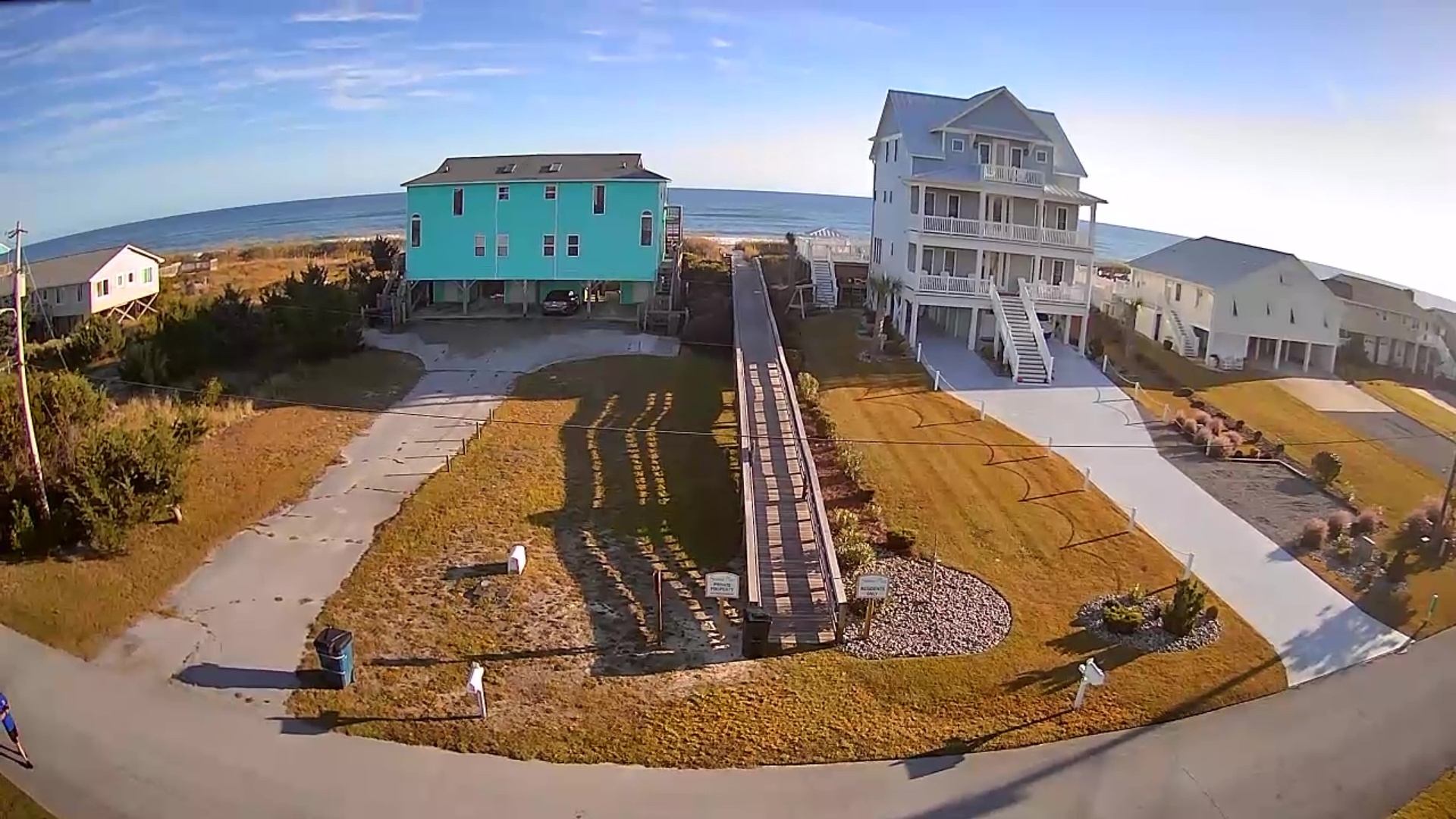 Elevated oceanfront homes with private beach walkway and panoramic coastal views in this premier beachside community.