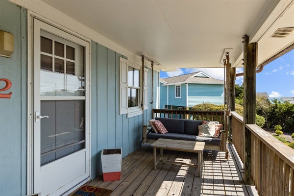 Unwind on your covered veranda with ocean breezes and charming coastal views.