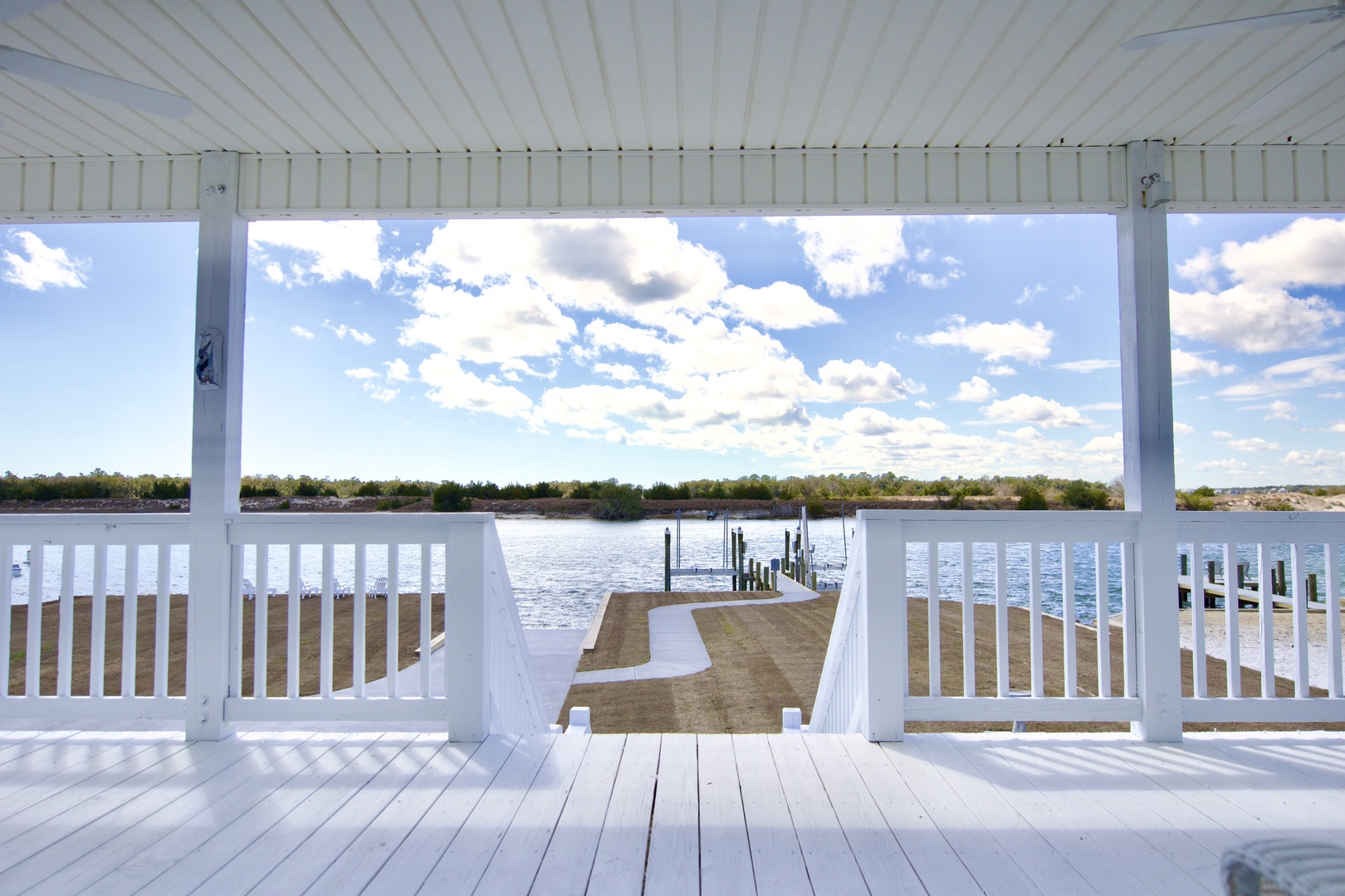 Step onto your private covered deck overlooking serene waters, where gentle breezes and panoramic views create the perfect retreat.