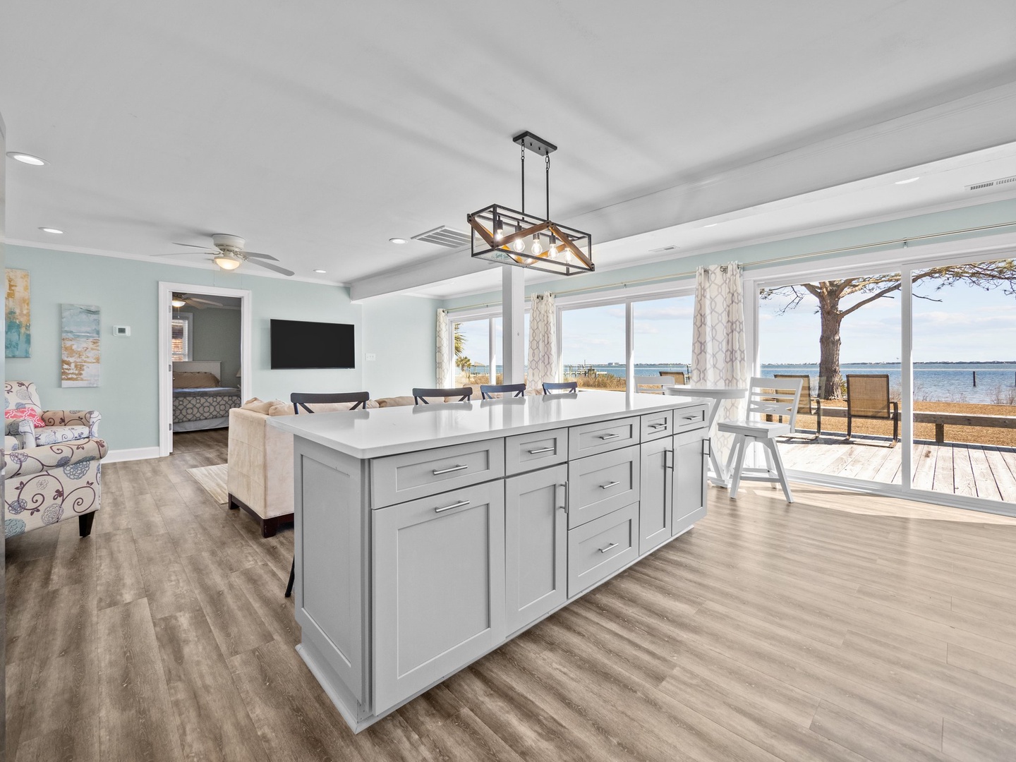 Your spacious kitchen island becomes the heart of your waterfront retreat, where you'll gather with loved ones while enjoying stunning sea views.