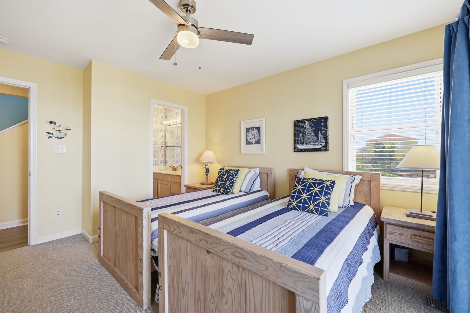 Rest easy in your bright and breezy bedroom, where coastal charm meets comfort. Twin beds with nautical linens invite peaceful sleep while ceiling fan and large window keep the space perfectly cool.