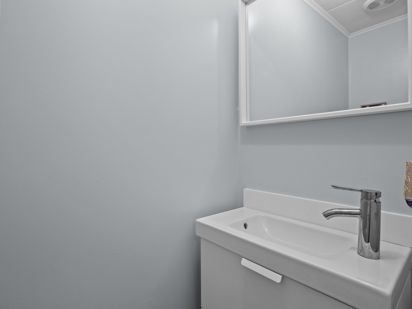 Freshen up in your private powder room with modern fixtures and sleek storage.