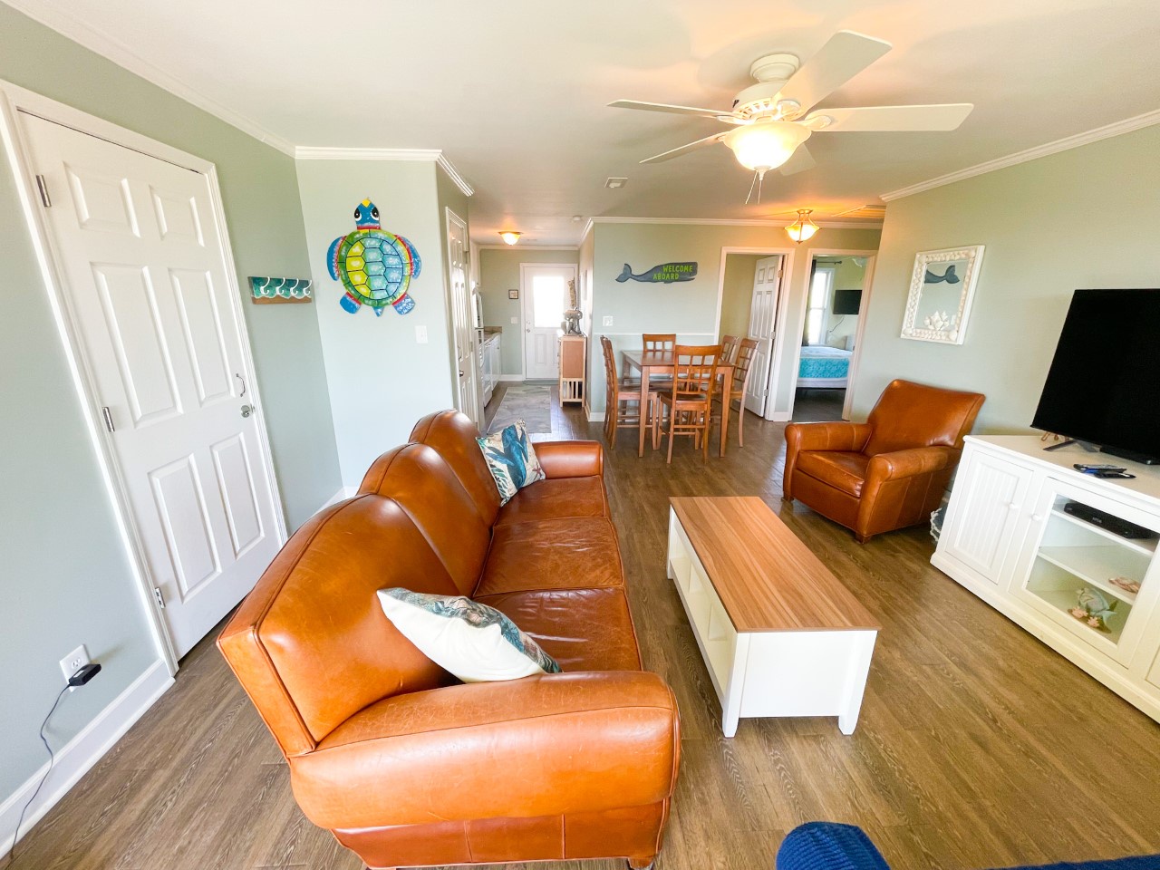 Sink into rich leather seating while you enjoy beach-themed decor and open-concept living that flows from lounge to dining area.