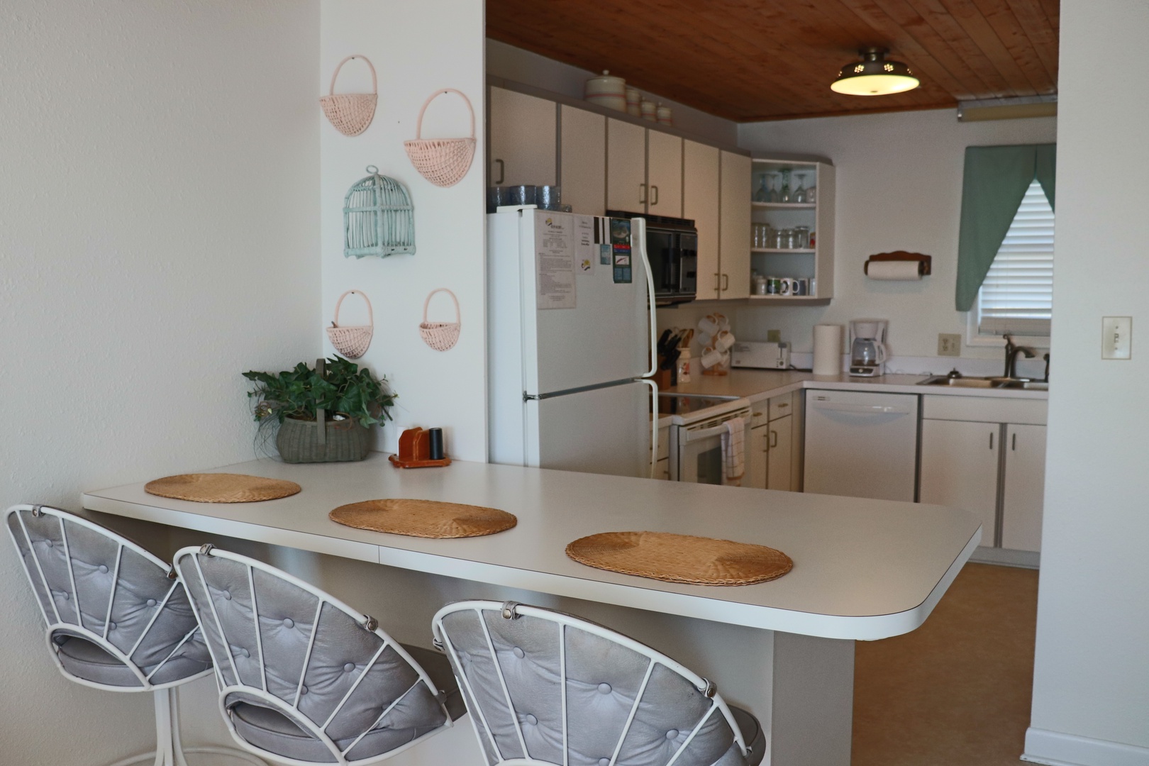 Your fully equipped kitchen with breakfast bar seating invites morning coffee and meal prep in this charming, homey space.