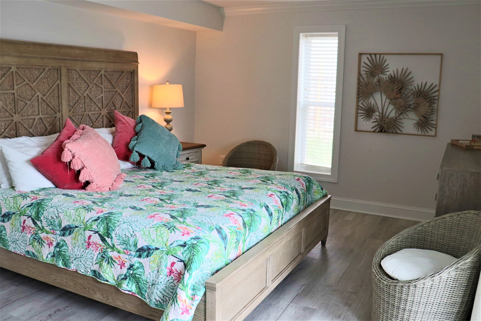 Drift off in your tropical paradise bedroom, where vibrant flamingo linens and wicker accents create a perfect island escape.