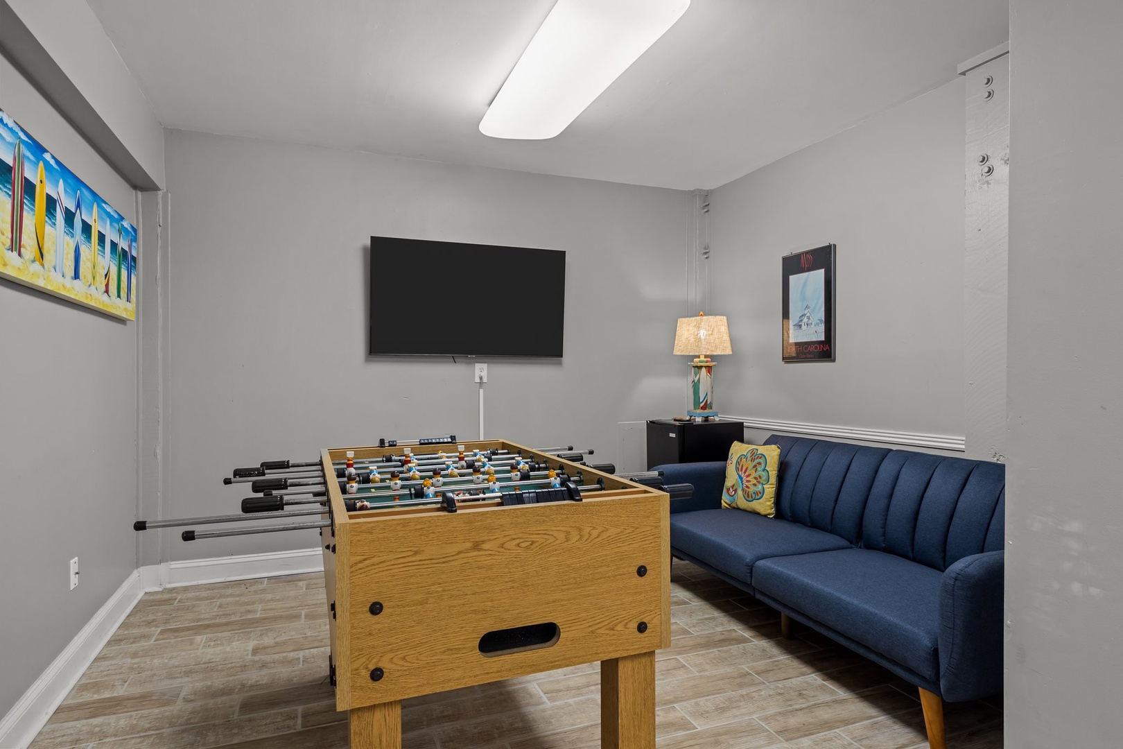 Challenge friends to foosball matches in your dedicated game room, complete with comfortable seating and wall-mounted TV for entertainment.