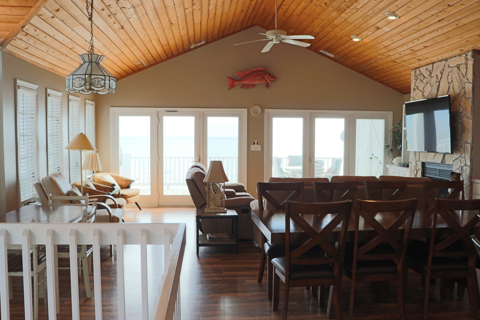 You'll love gathering in this stunning open-concept space with soaring wood ceilings, where your dining and living areas flow seamlessly together for perfect entertaining.