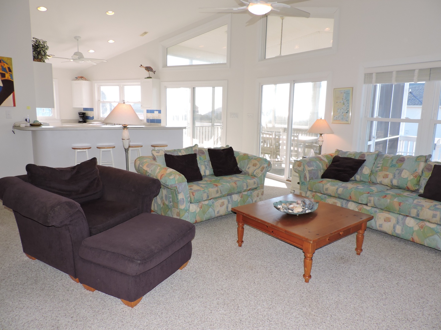 Relax in your bright, open living space with comfortable seating and soaring ceilings that create an airy, welcoming atmosphere.