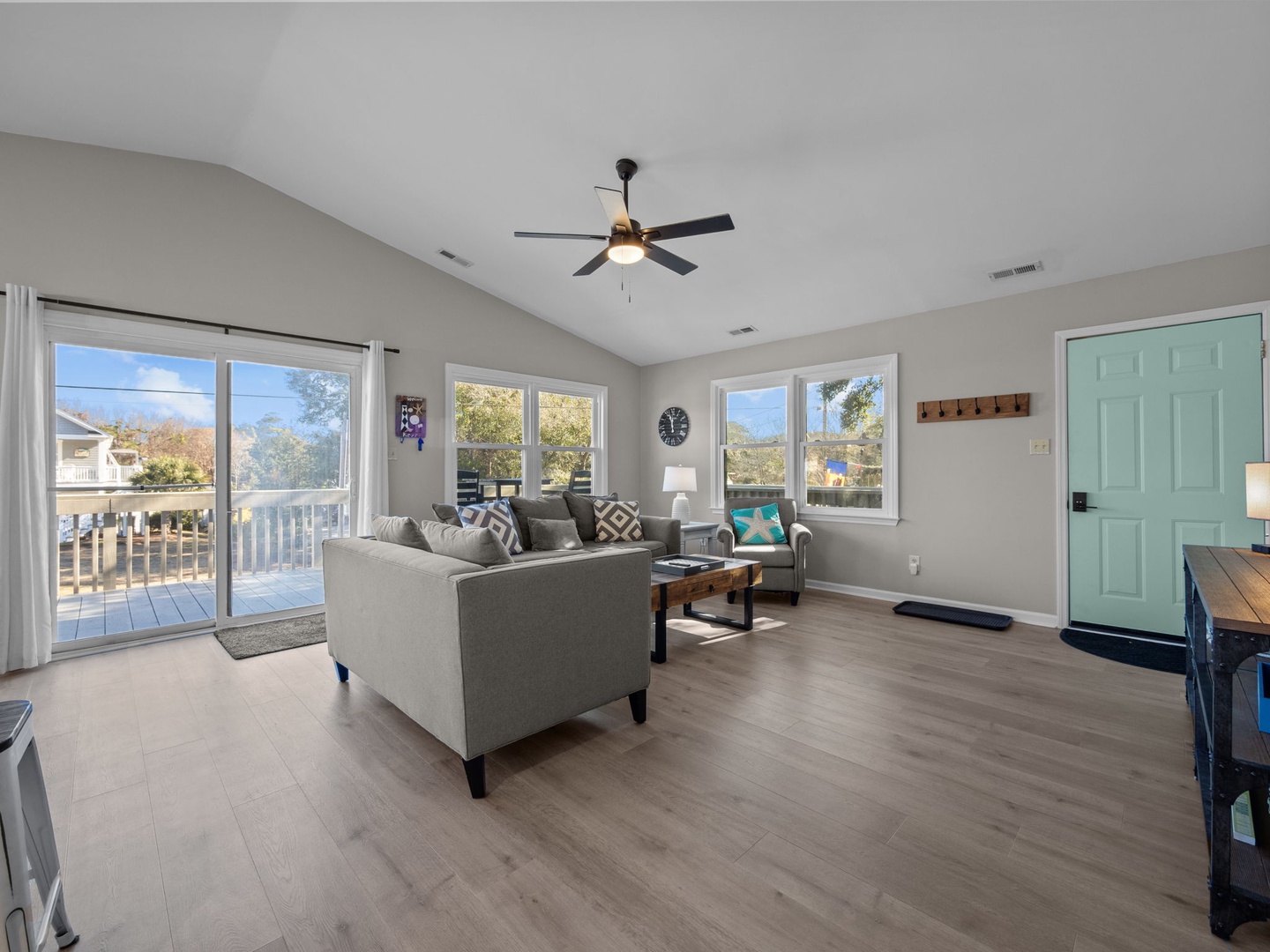 Relax in your bright living room with plush seating and mountain views through large windows that fill the space with natural light.