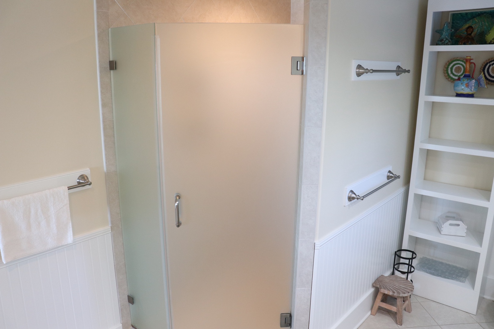 Step into your private spa-like bathroom with frosted glass shower, deep soaking tub, and thoughtful built-in storage for all your essentials.