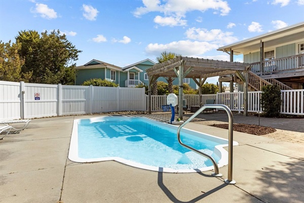Dive into relaxation at your private pool oasis, complete with poolside lounging and sunny blue skies overhead.