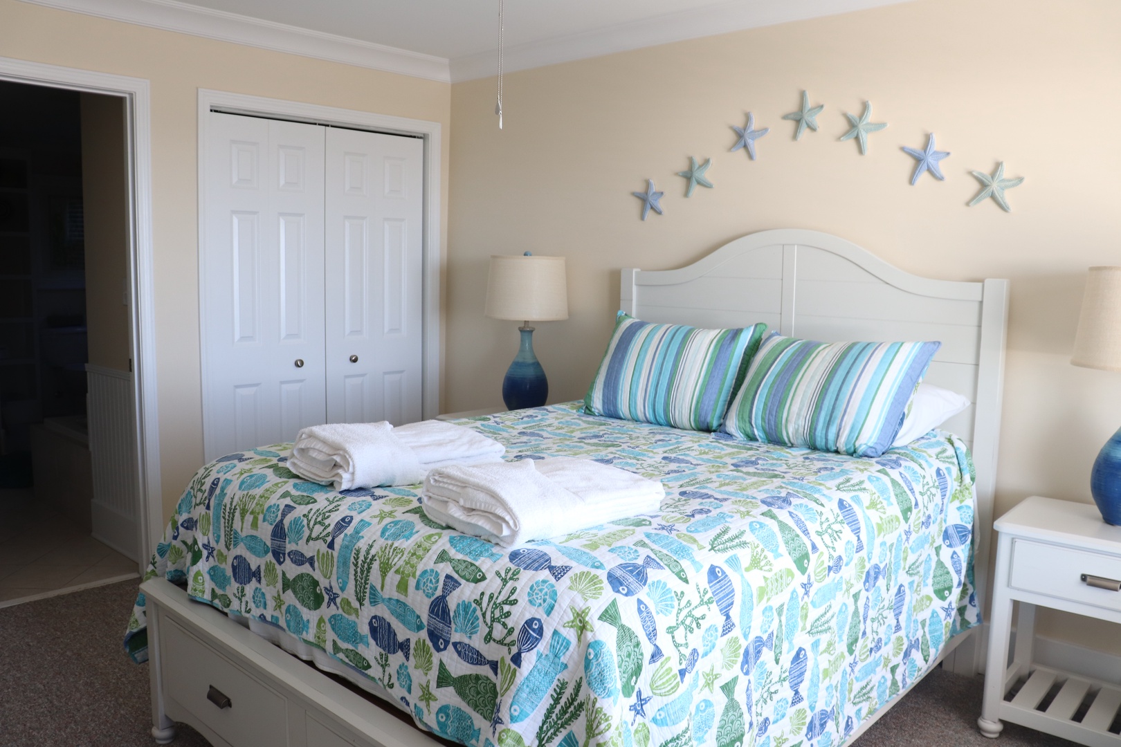 Drift off to sleep surrounded by soothing coastal charm in your peaceful bedroom retreat with ocean-inspired decor and fresh linens.