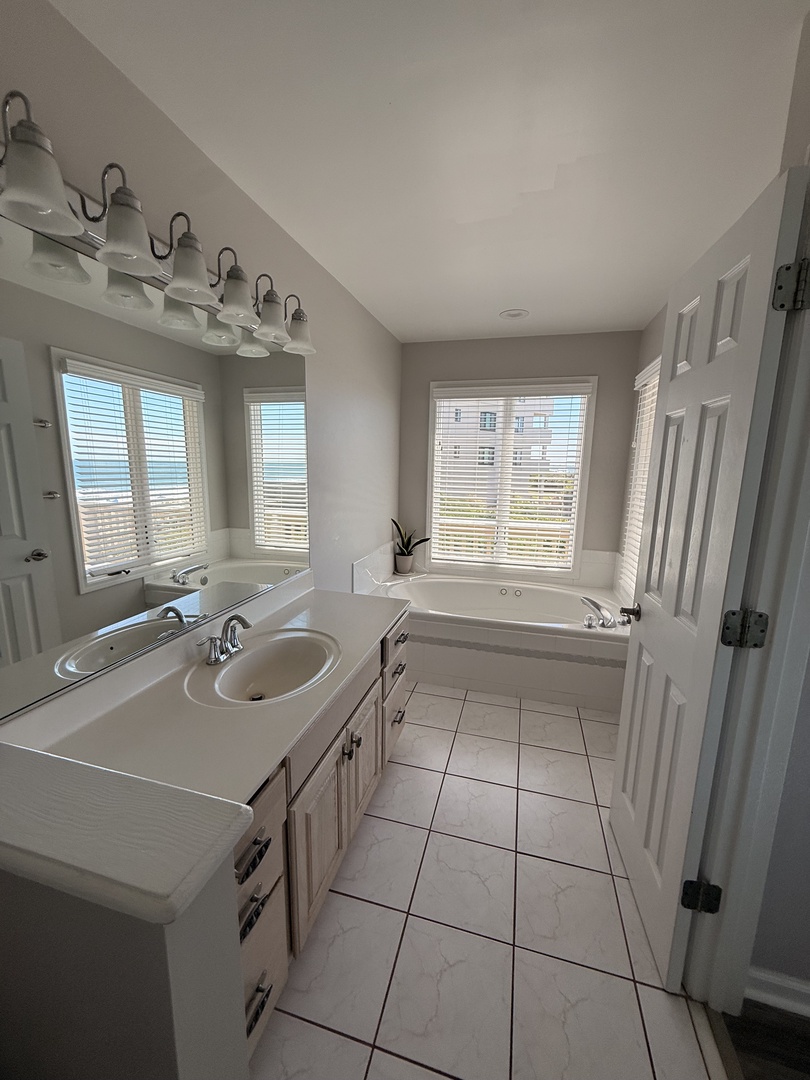Step into your private spa-like bathroom where natural light floods the space, highlighting the sleek modern fixtures and calming neutral tones that create your perfect retreat.