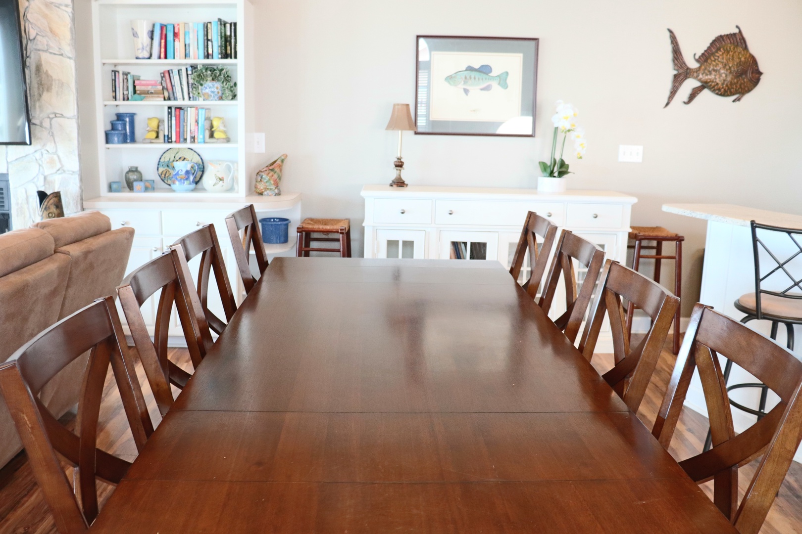 Gather your group around this spacious dining table for memorable meals together, surrounded by coastal charm and built-in storage.
