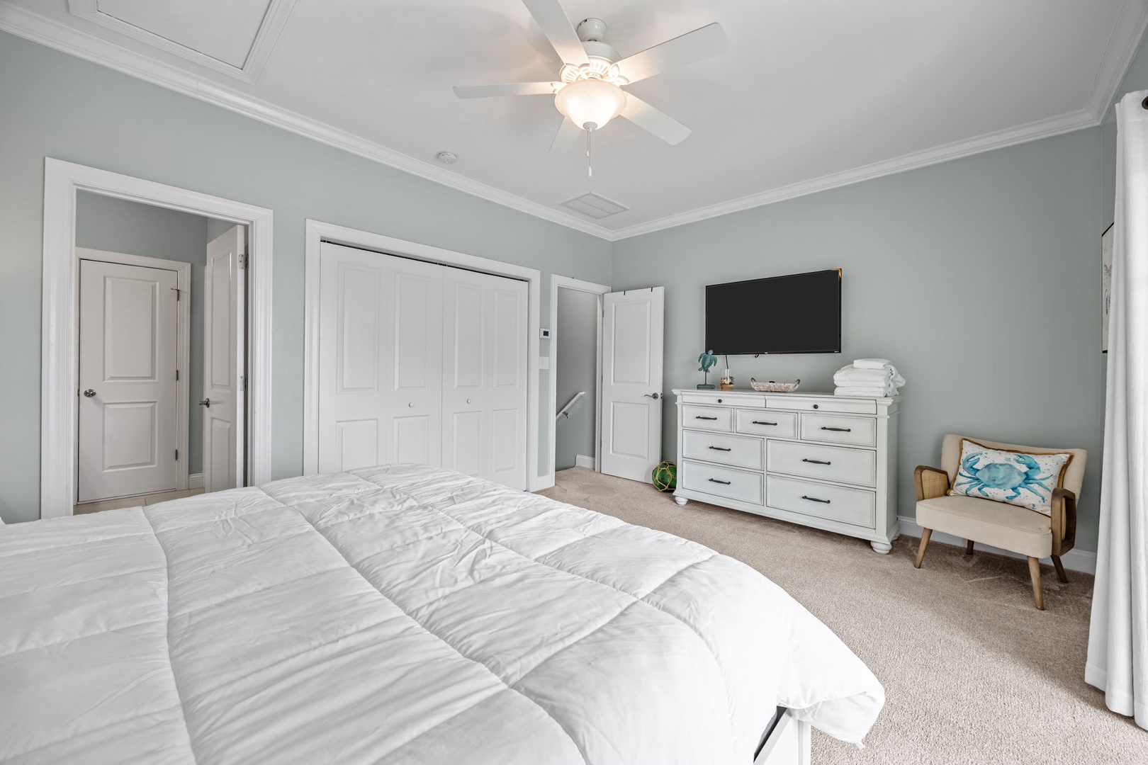Unwind in your serene master bedroom with coastal colors, cozy seating, and all the comforts for a perfect night's rest.