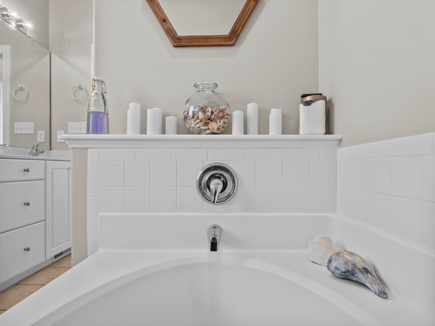 Sink into your private soaking tub surrounded by peaceful white tiles and thoughtful touches—your perfect retreat for unwinding after exploring.