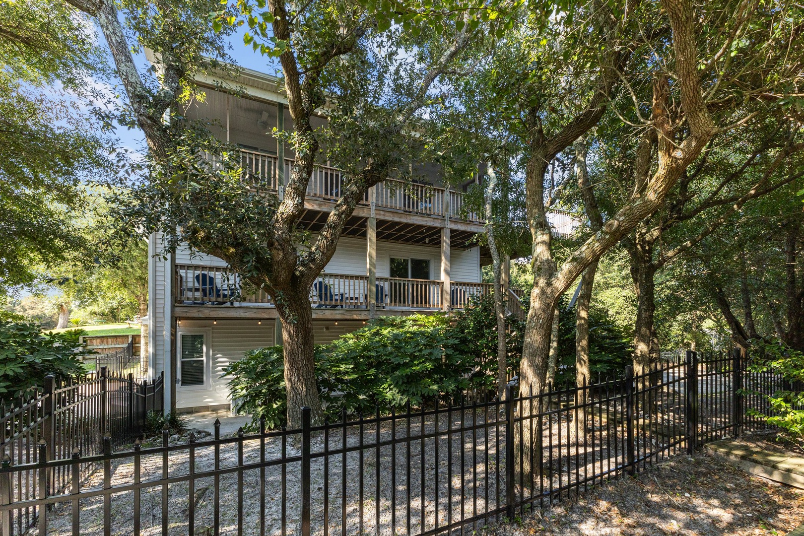 Multi-level retreat nestled among mature trees, featuring spacious balconies and natural privacy for your peaceful getaway.