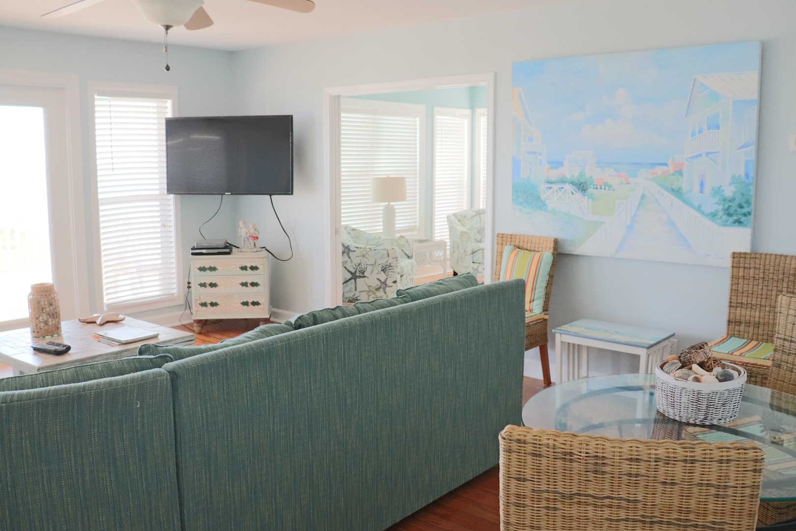 Unwind in your bright living space with comfy seating, coastal artwork, and entertainment ready for relaxing evenings.