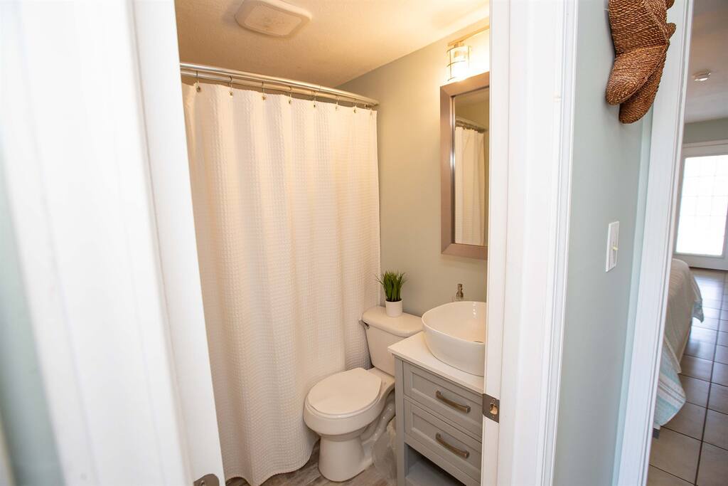 Your private bathroom features a modern vessel sink and rainfall shower, creating a spa-like retreat after exploring the area.