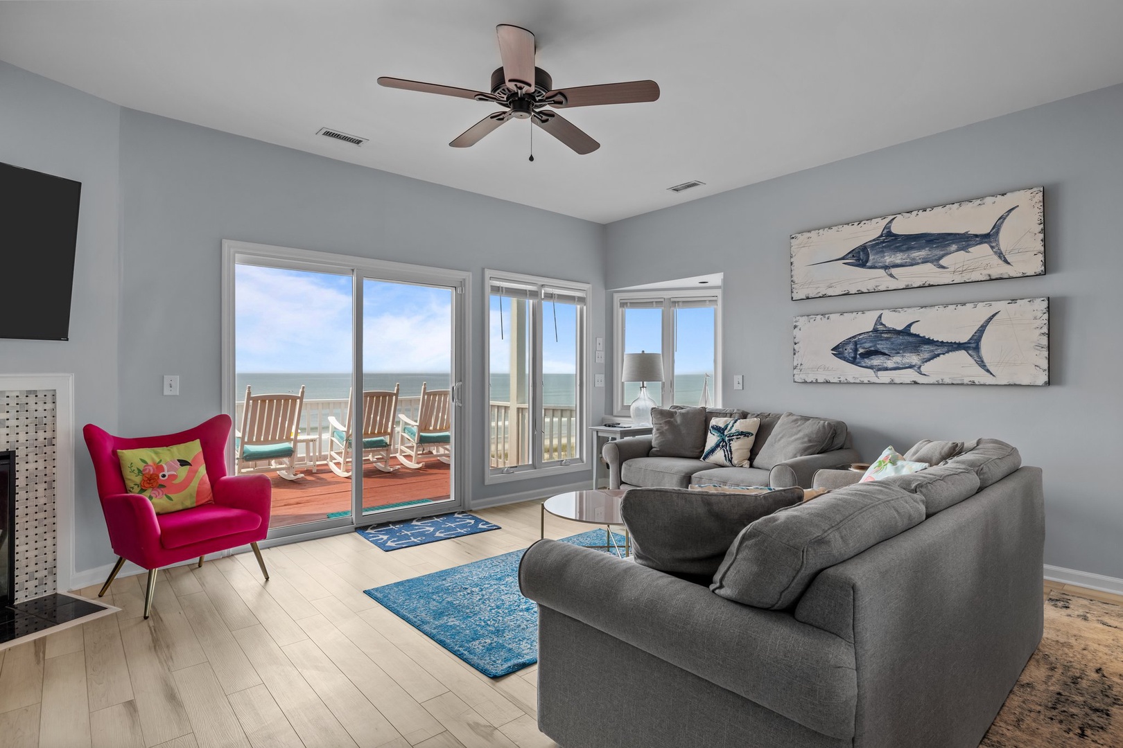 Unwind in your bright living room where ocean views through sliding doors create the perfect coastal retreat for relaxation.