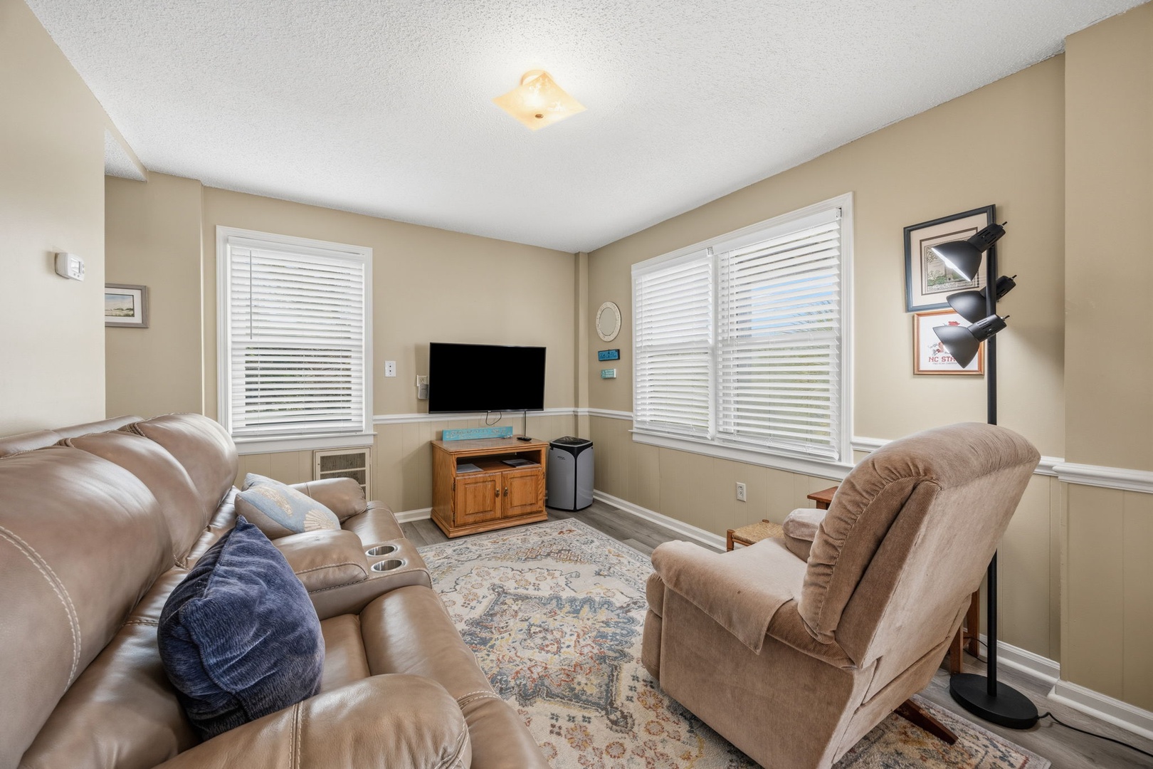Sink into plush leather recliners while watching your favorite shows on the flat-screen TV in this cozy living room.