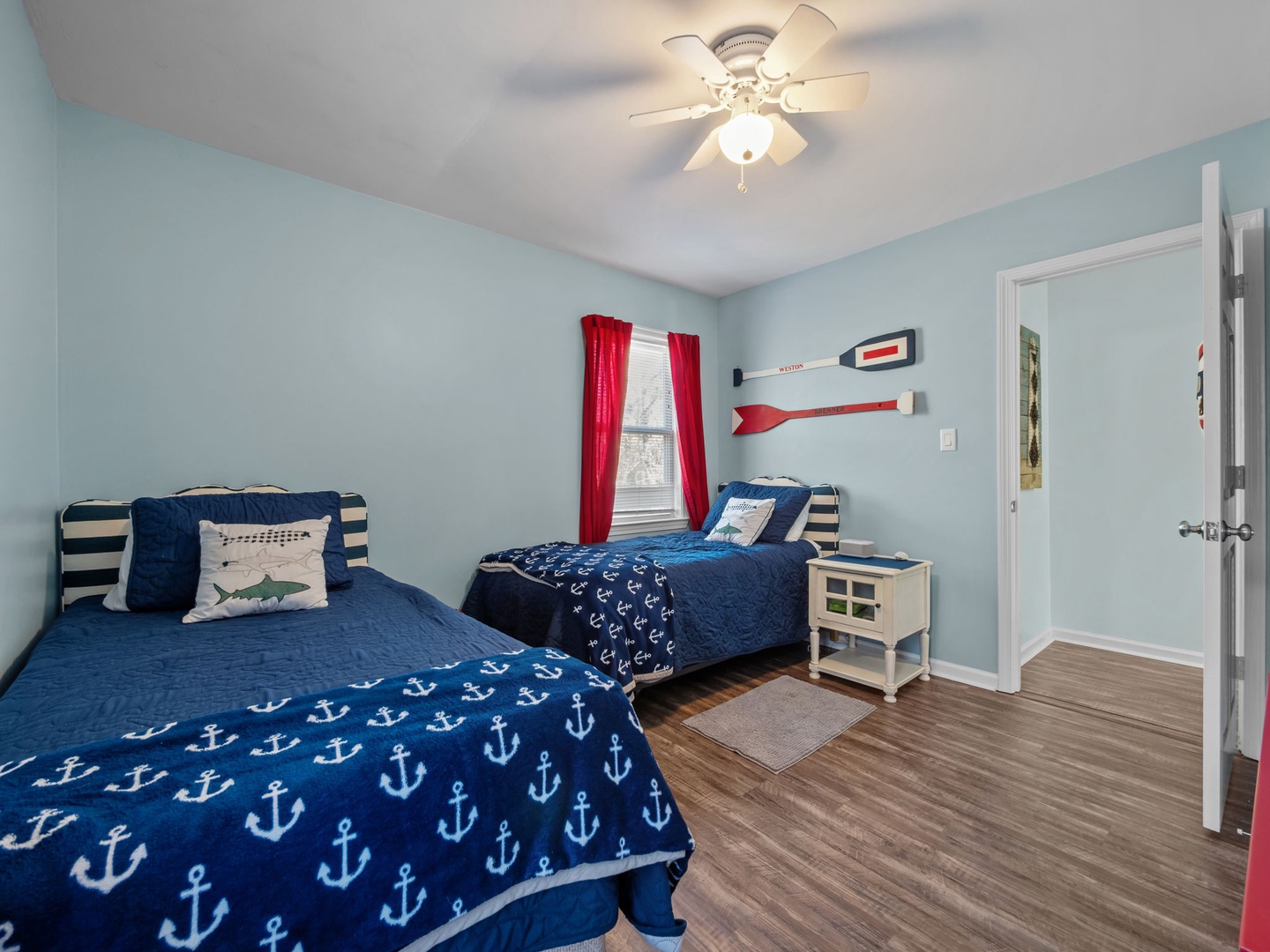 Drift off to sleep in your nautical-themed bedroom with twin beds, ceiling fan, and charming seaside decor that kids will love.