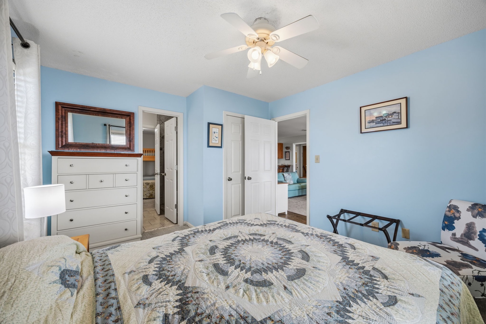 Relax in your peaceful bedroom with soothing blue walls, ceiling fan, and storage. The adjoining bathroom offers convenient access.