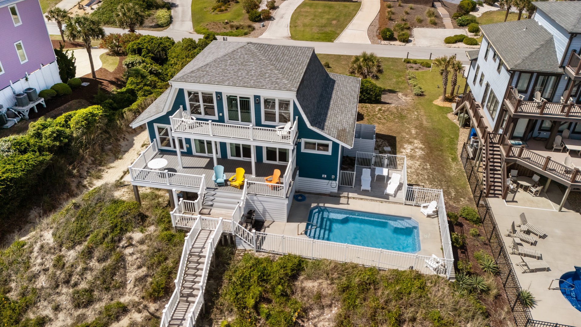 Coastal retreat with private pool, spacious decks, and beach access in a quiet neighborhood setting.