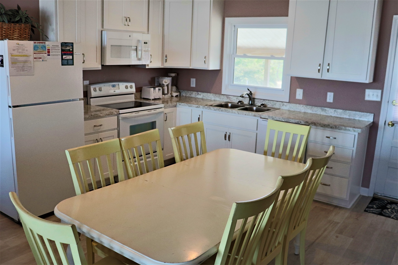 Your spacious kitchen features granite countertops, full appliances, and a sunny dining table perfect for family meals together.