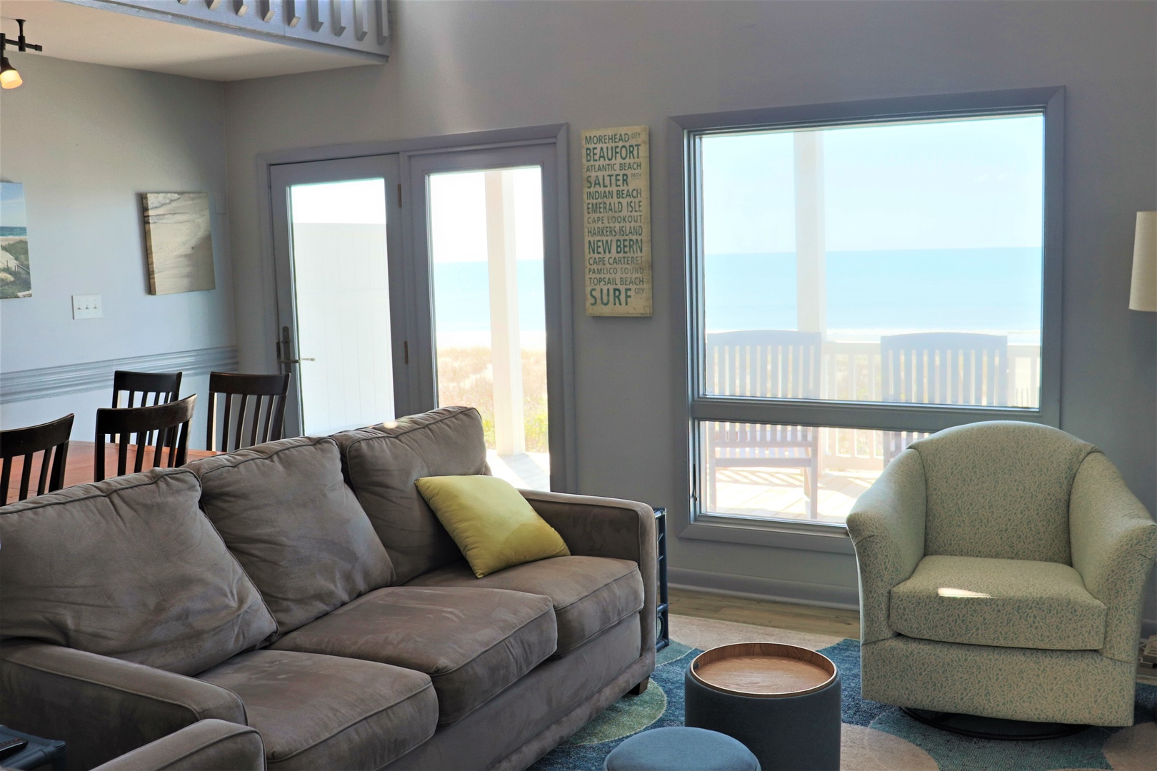 Sink into coastal comfort in your bright living space, where ocean views frame your beachside escape.