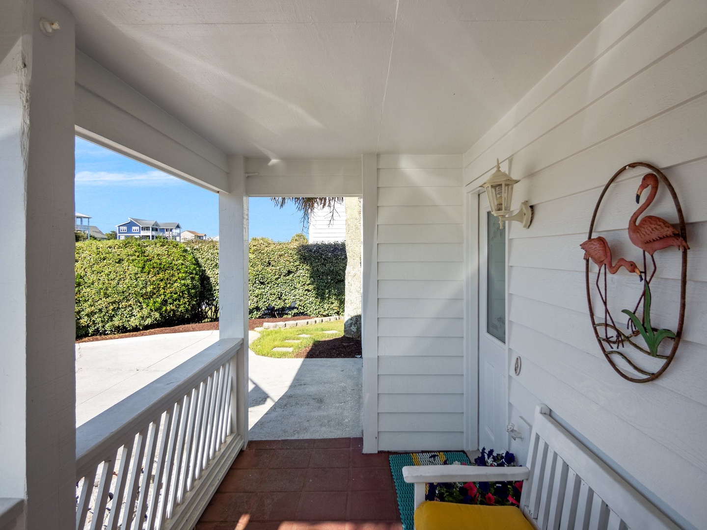 Welcoming coastal porch where you can sip morning coffee surrounded by tropical charm and neighborhood views.