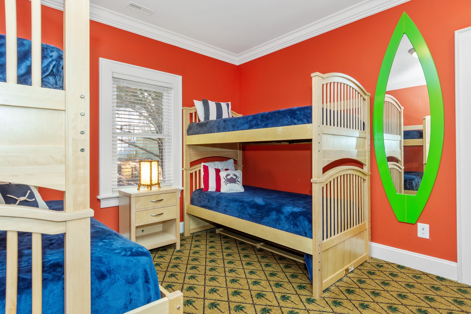 Your kids will love this vibrant nautical bunk room with comfortable beds and playful decor.