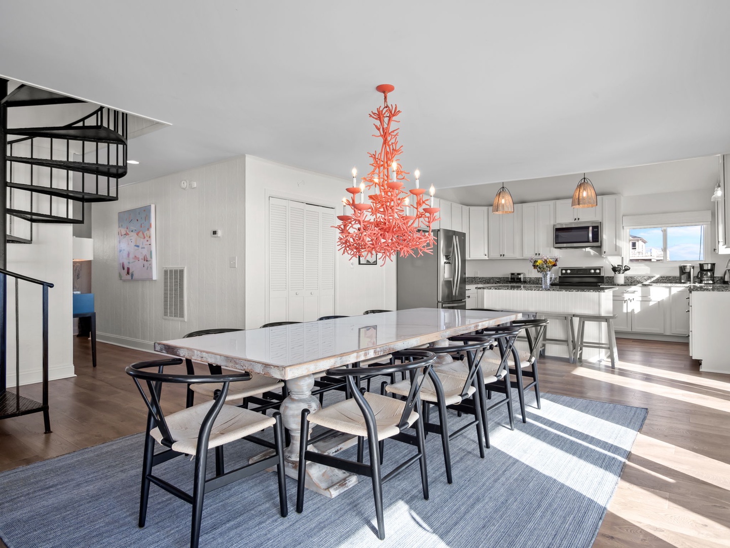 Gather around your spacious dining table beneath the striking coral chandelier, with a fully equipped kitchen ready for memorable meals together.