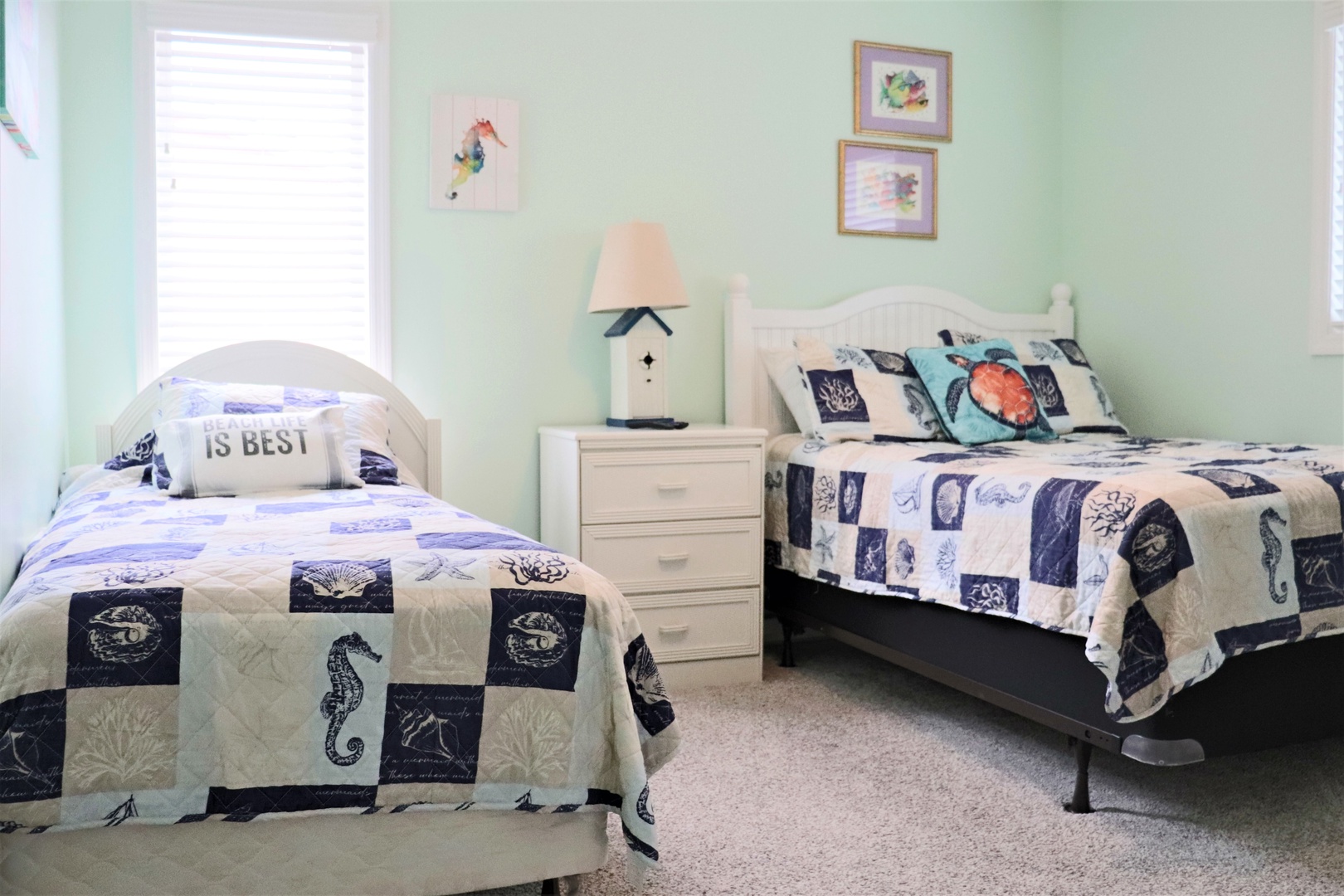 Drift off to sleep in this peaceful twin bedroom with nautical themes and gentle green walls creating your perfect coastal retreat.