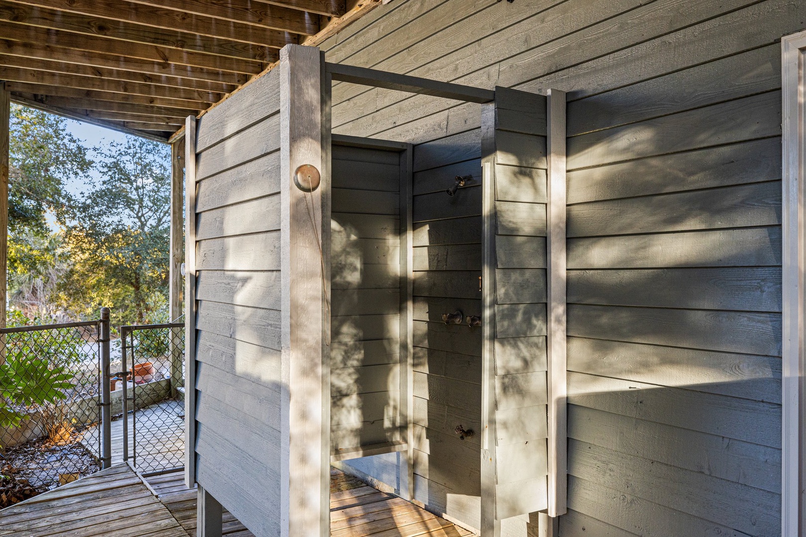 Step into your private outdoor shower sanctuary, where natural light filters through overhead beams creating the perfect blend of privacy and connection with nature.