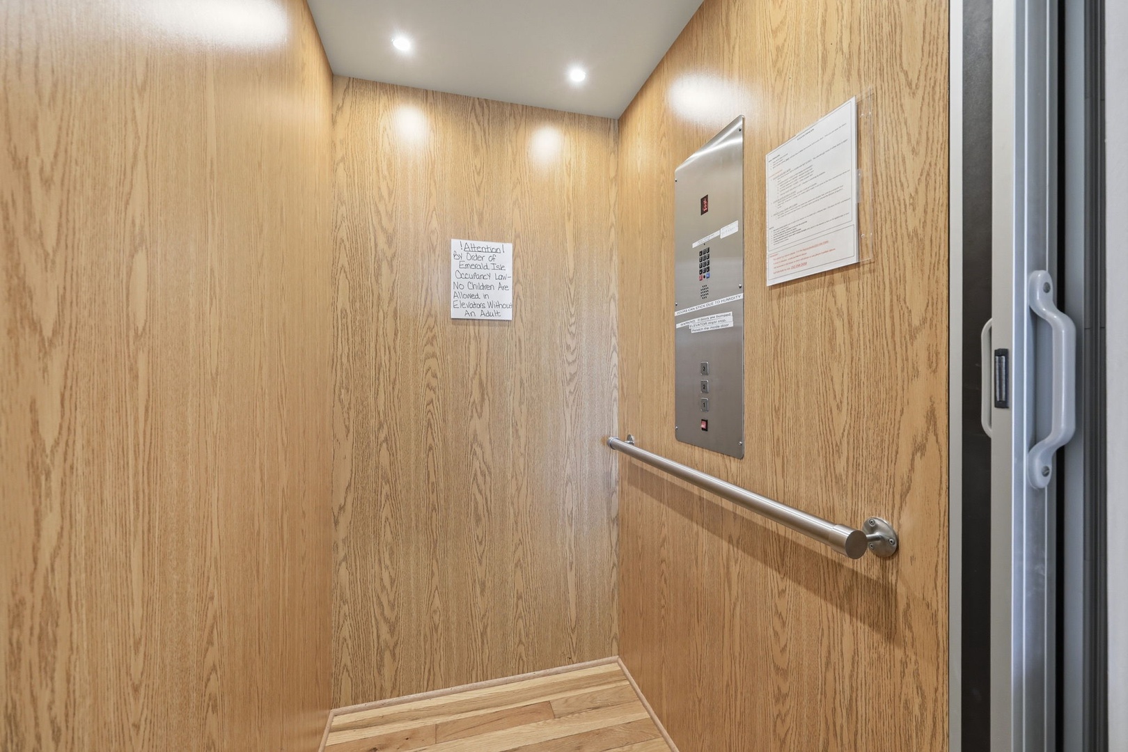 The property includes an elevator with modern paneling and handrails for easy, accessible movement between floors.