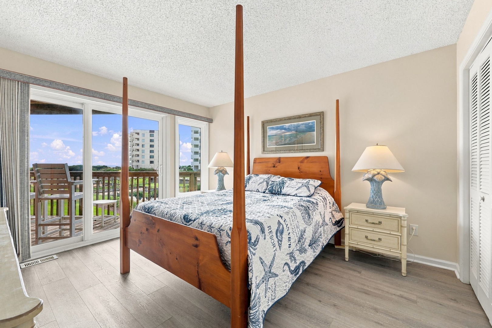 Wake up in a serene bedroom with coastal charm and step onto your private balcony to soak in peaceful surroundings—your restful retreat awaits.