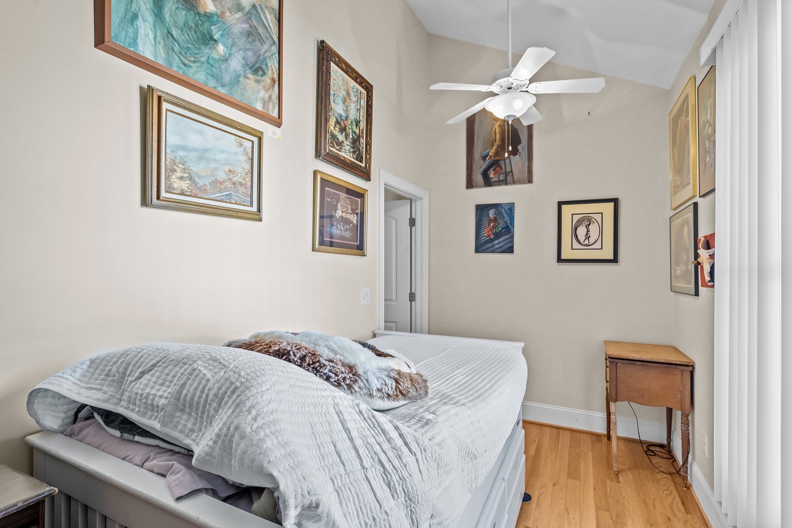 Drift off in your art-filled bedroom where local artwork creates a gallery-like ambiance and the ceiling fan ensures perfect comfort.