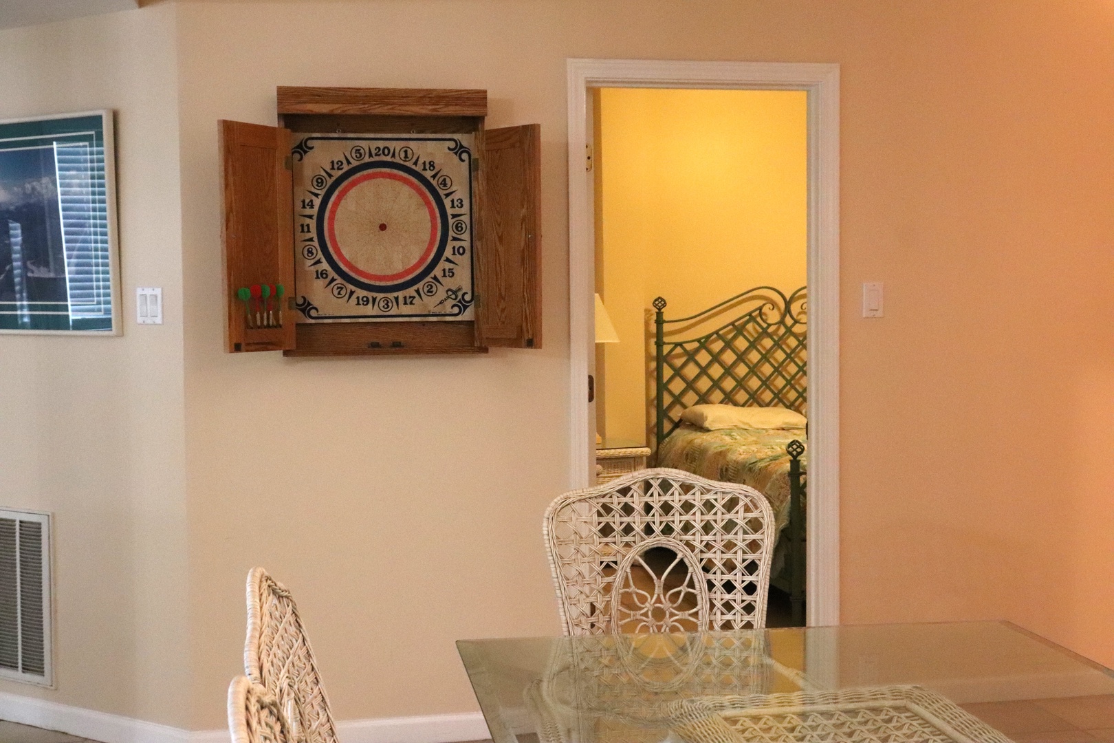 Enjoy friendly games at your glass dining table, then peek into the cozy bedroom with its elegant lattice headboard.