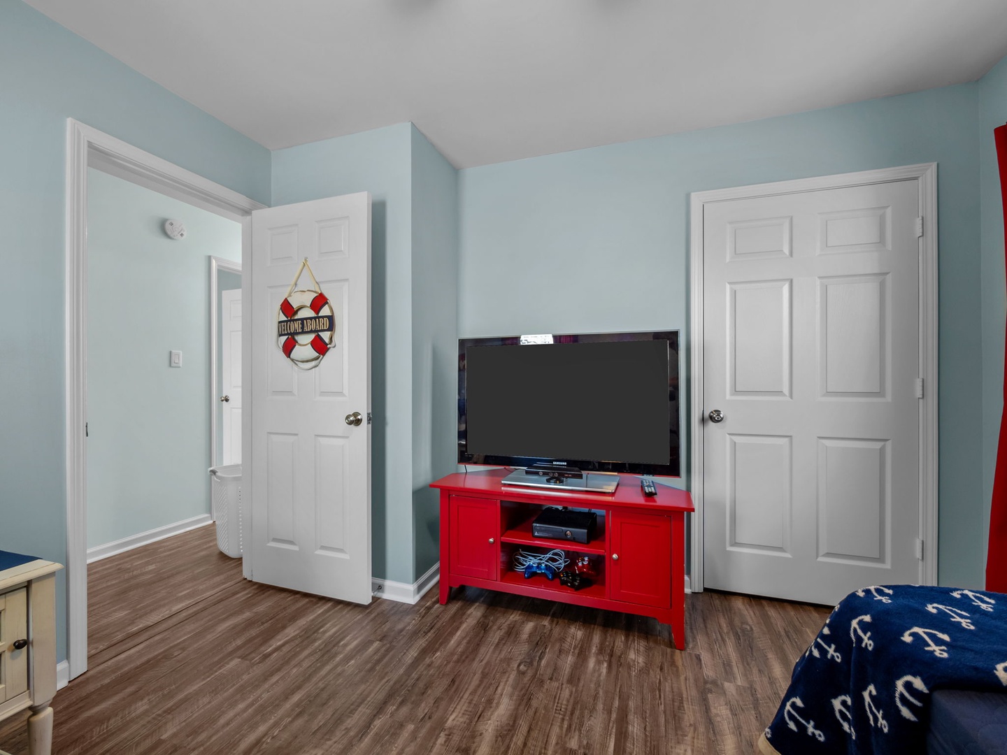 Your nautical-themed room features a flat-screen TV on a bright red console, perfect for movie nights after exploring.