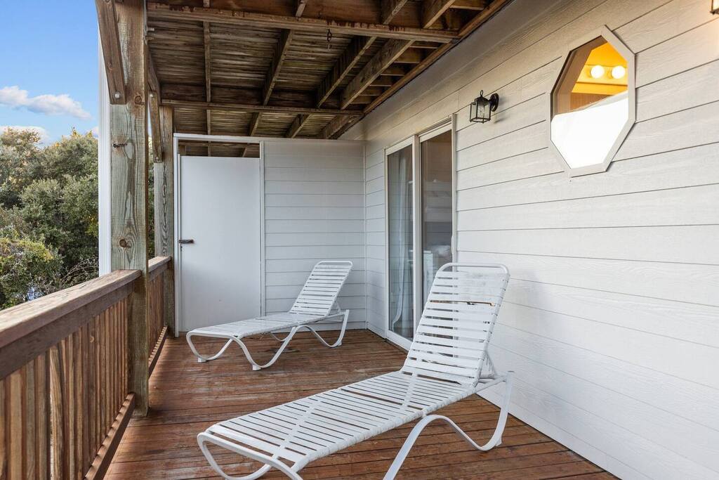 Unwind on your private deck with comfortable lounge chairs, soaking up sunshine while overlooking peaceful treetops.