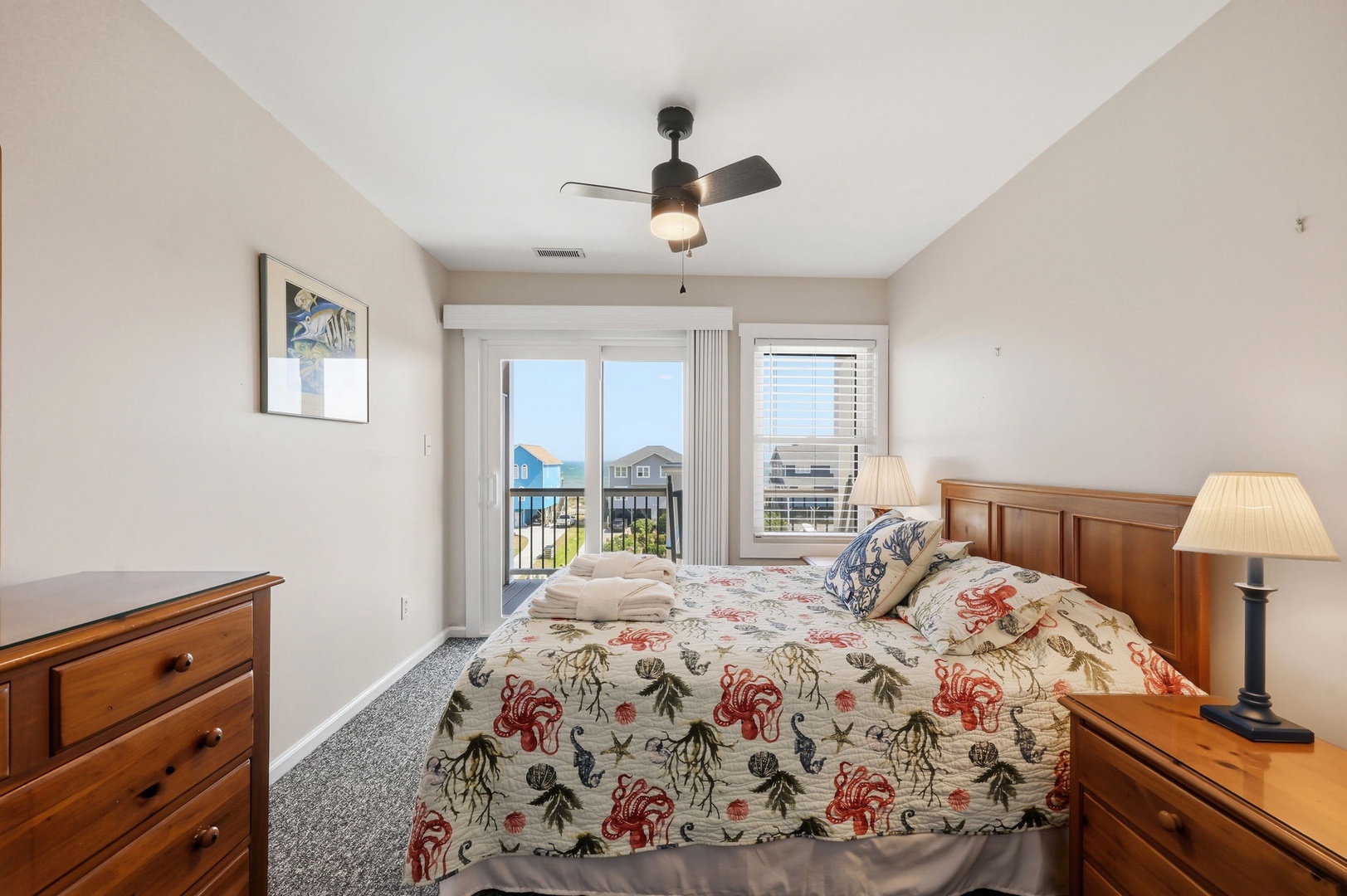 Wake up to coastal breezes and neighborhood views from your comfortable bedroom, where natural light fills the space and charming seaside décor welcomes you to start each vacation morning refreshed.