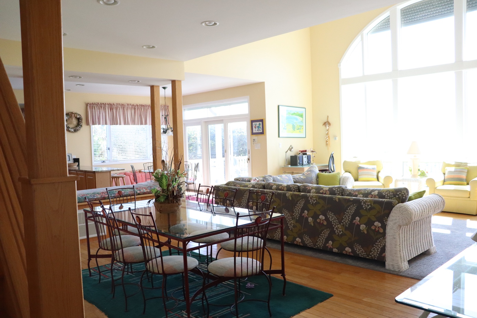 Relax in your bright, airy living space with comfortable seating areas and natural light streaming through large windows.