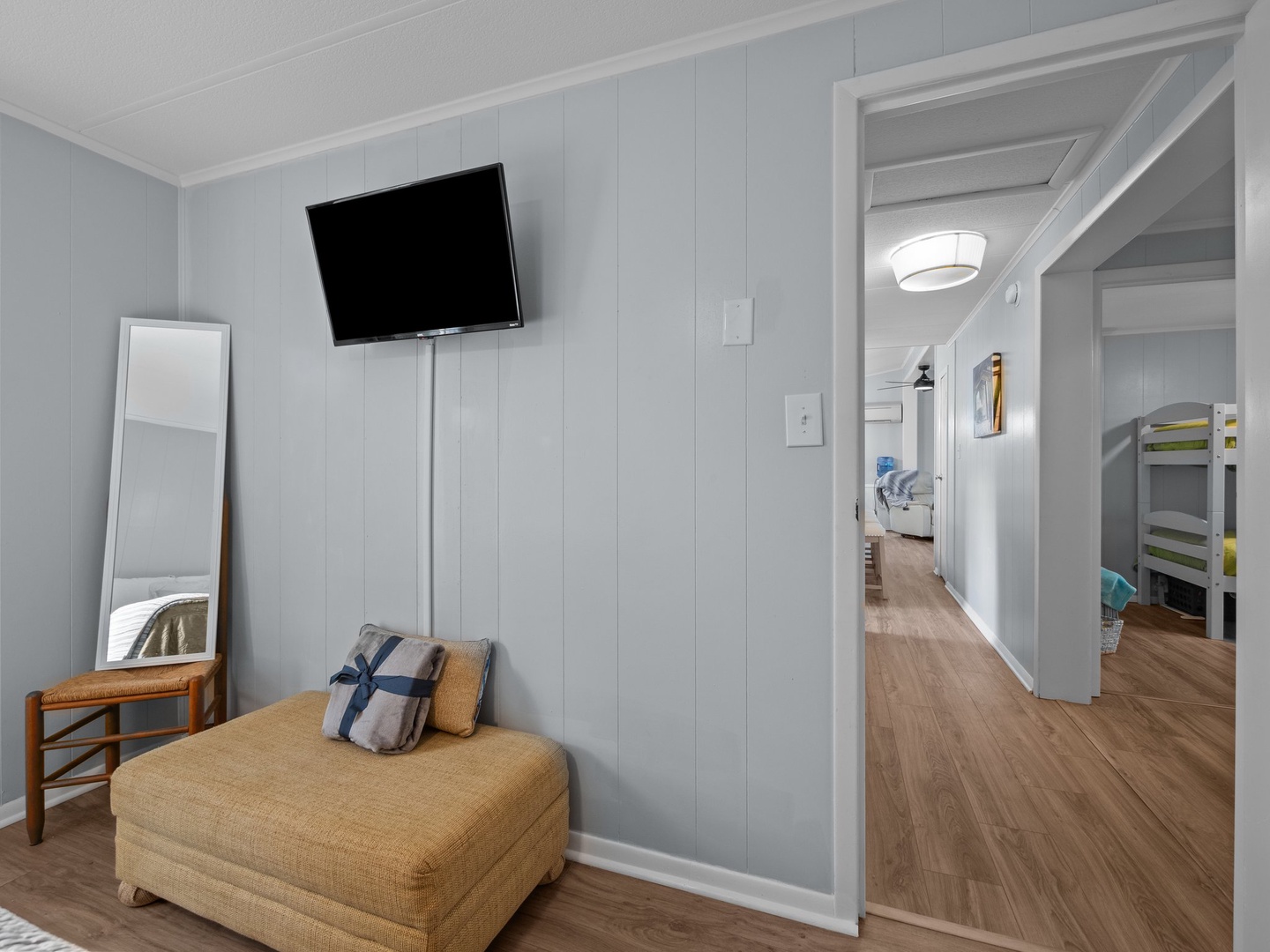 Your private retreat features a cozy reading nook with plush seating and entertainment, while natural light flows through open spaces.