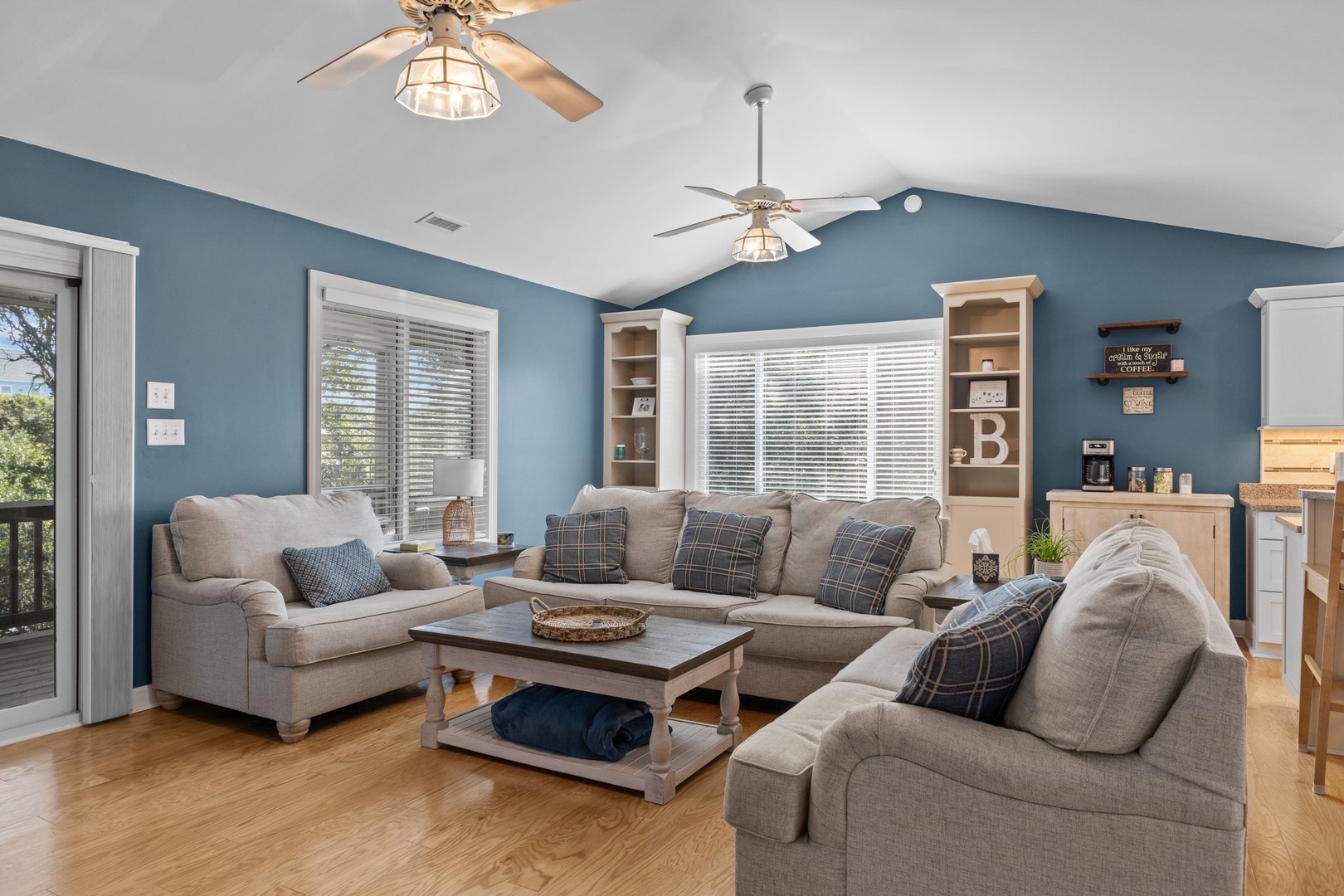 Settle into your cozy living space with plush seating and coastal blue walls that instantly put you at ease.