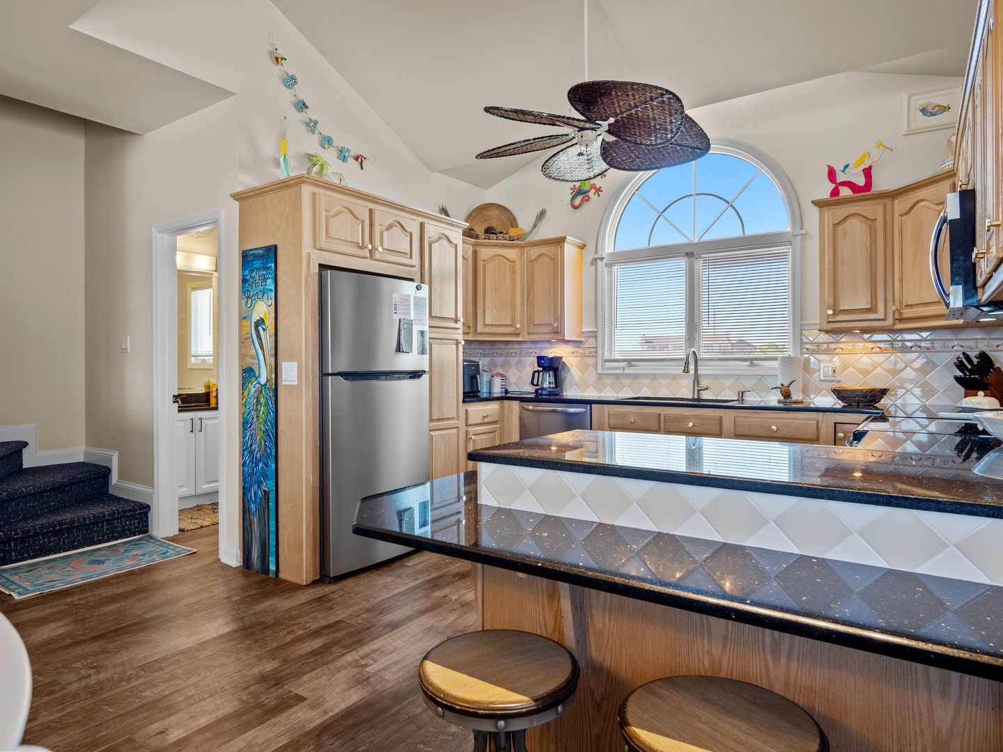 Your fully-equipped kitchen features granite counters, stainless appliances, and a breakfast bar where you can sip morning coffee while planning beach adventures.