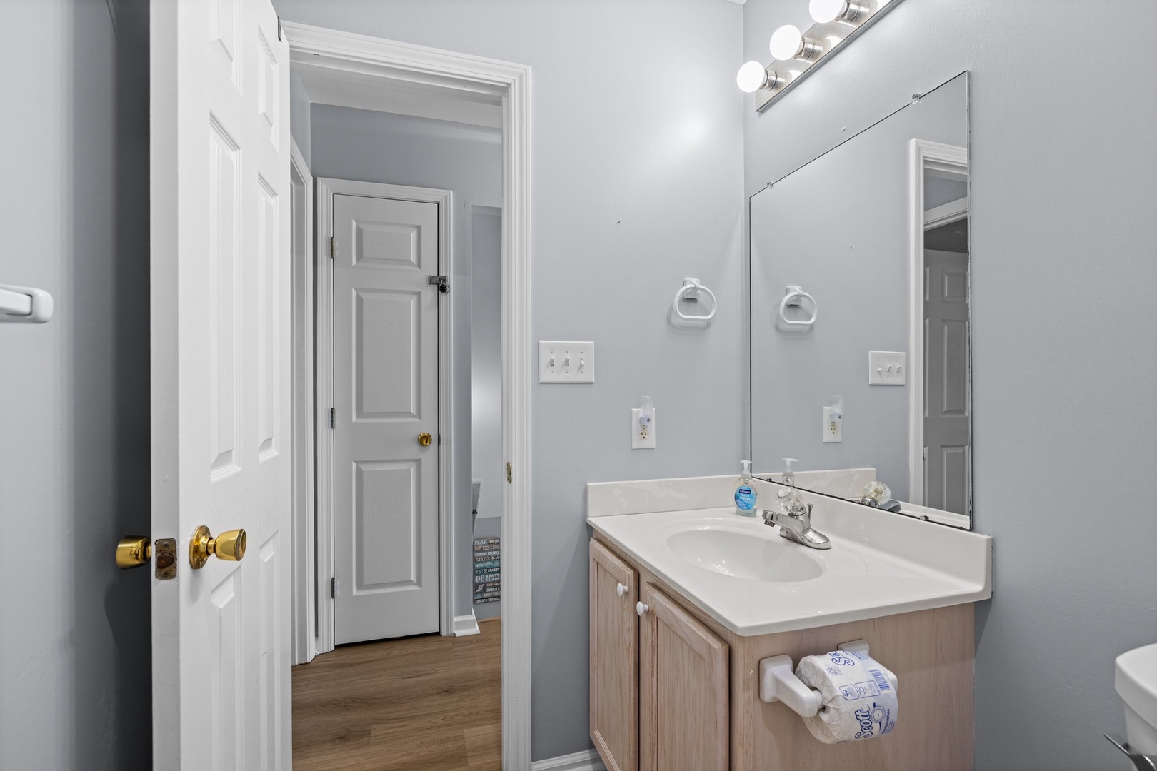 Step into your bright, modern bathroom with vanity lighting and clean finishes for your daily routines.