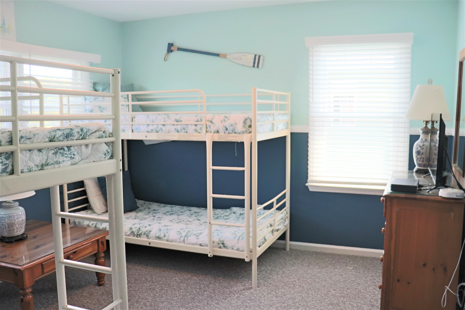 Your coastal-themed bedroom features cozy bunk beds perfect for family adventures, with charming nautical touches and plenty of natural light.